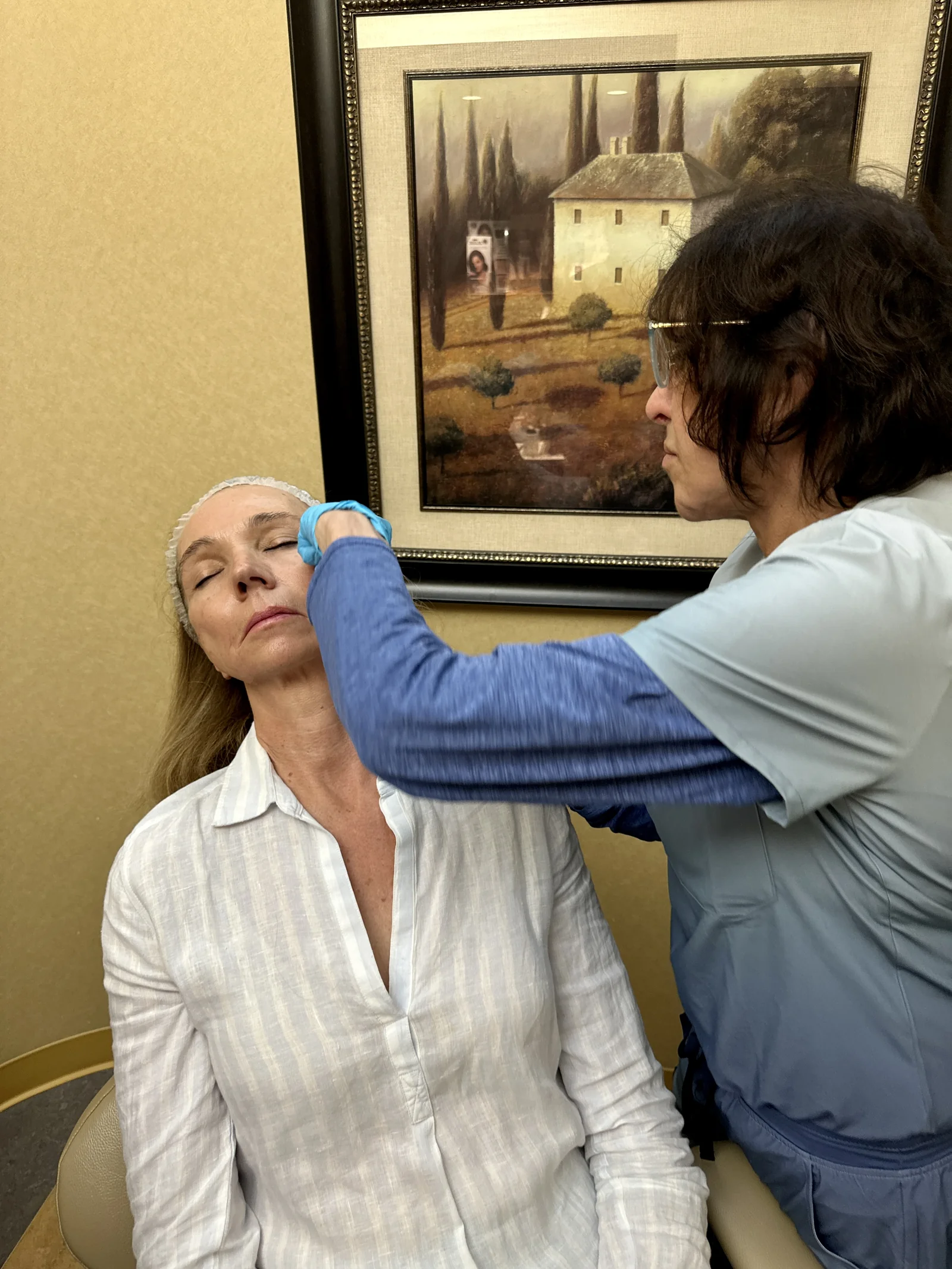 Dr. Gayle Misle preparing a patient's cheek area for treatment at Reviv Med Spa, Millbrae